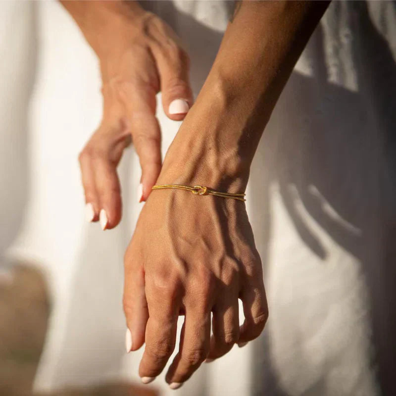 Minimalist knot bracelet for women, elegant and subtle stainless steel daily wear jewelry.