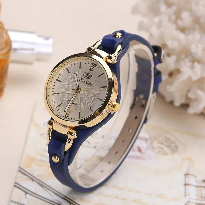 Close-up of a ladies' engraved dial quartz watch featuring a stylish vegan leather band.