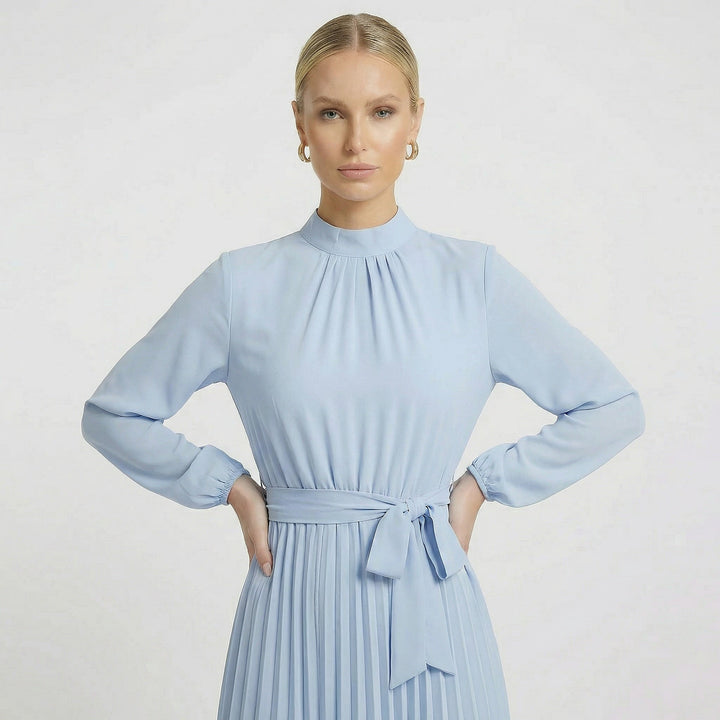 Women's light blue midi dress featuring long sleeves, a belt, and elegant pleats.