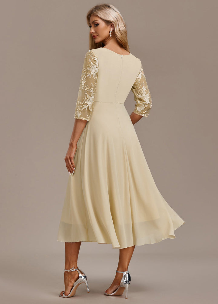 Women's elegant light yellow midi dress with intricate embroidery, round neck, and 3/4 sleeves; ideal for occasions.