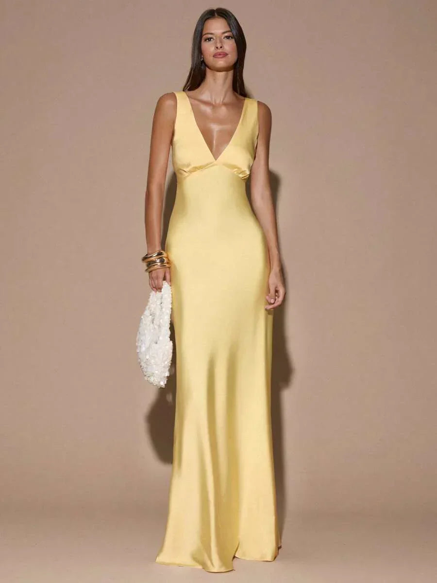 Women's elegant light yellow backless maxi dress with V-neck & graceful mermaid hem, ideal for formal parties.