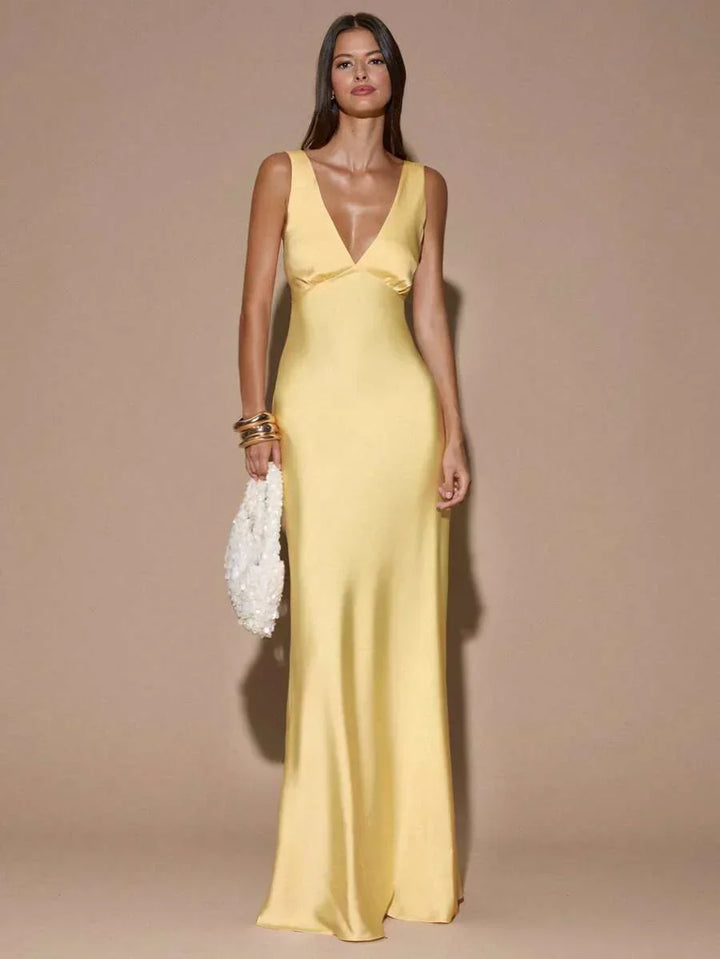 Women's elegant light yellow backless maxi dress with V-neck & graceful mermaid hem, ideal for formal parties.