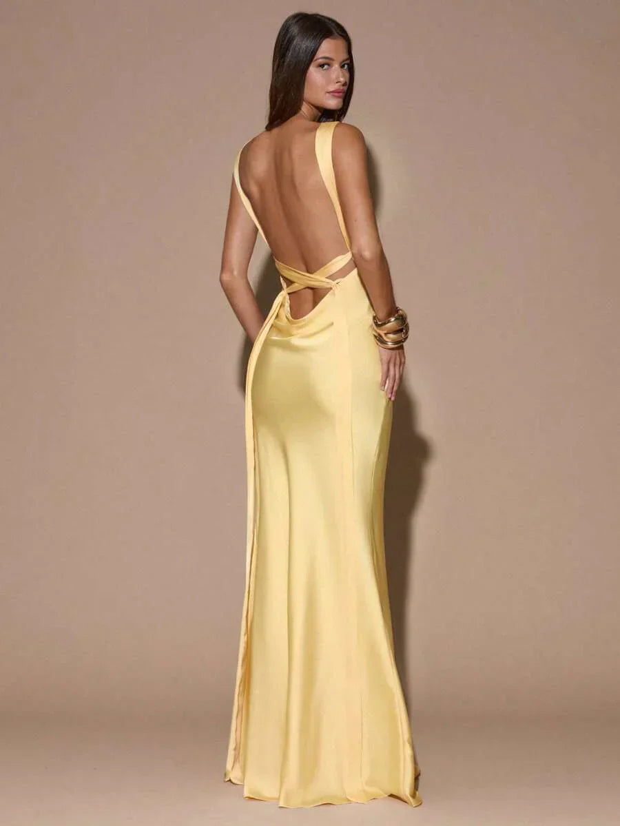 Graceful women's light yellow formal maxi gown, featuring a V-neck, backless design, perfect party dress for guests.