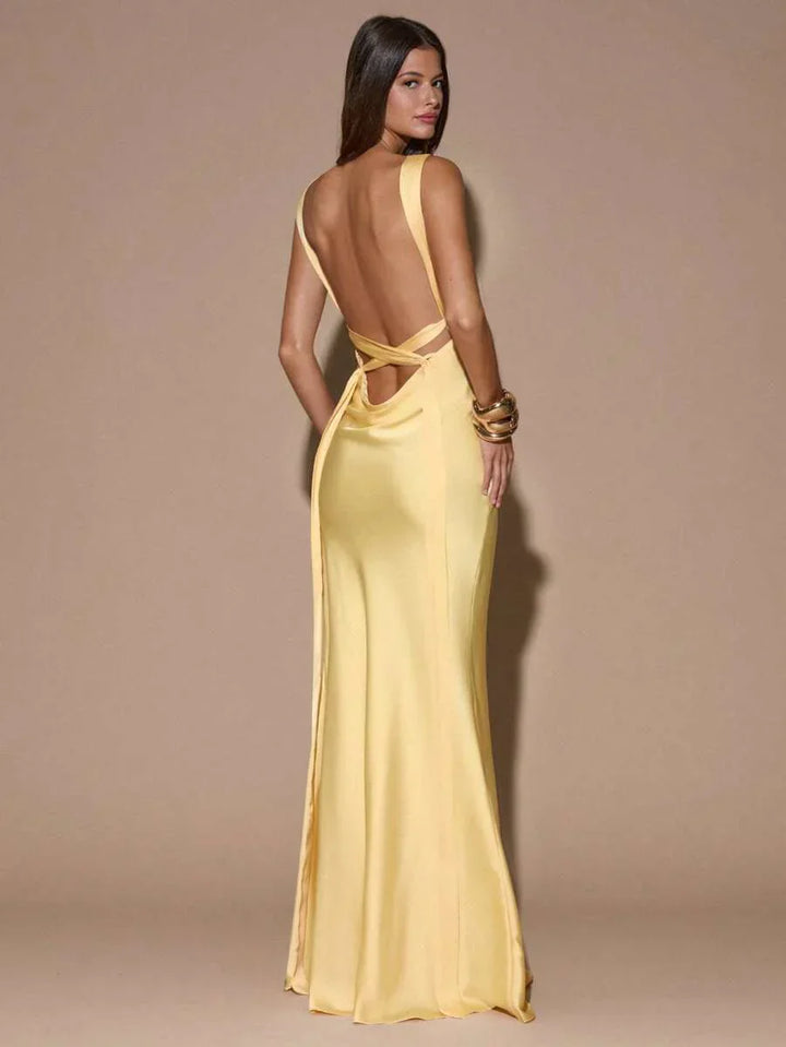 Graceful women's light yellow formal maxi gown, featuring a V-neck, backless design, perfect party dress for guests.