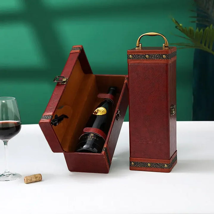 Luxury beverage carrier, black leather, with space for wine bottles & associated accessories.
