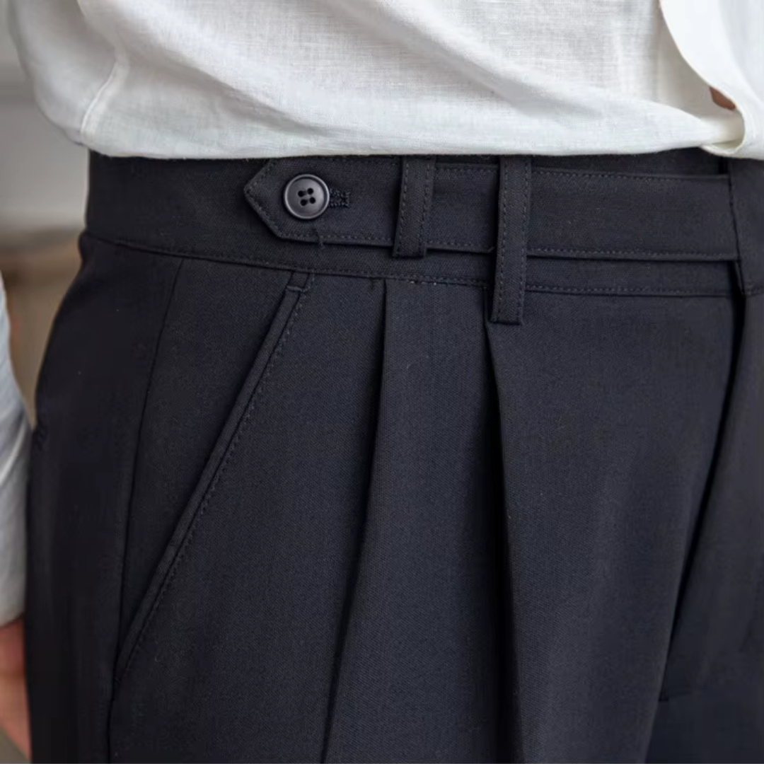 Dark men's elegant pleated trousers, a versatile choice for modern formal & smart casual outfits.