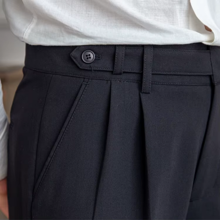 Dark men's elegant pleated trousers, a versatile choice for modern formal & smart casual outfits.