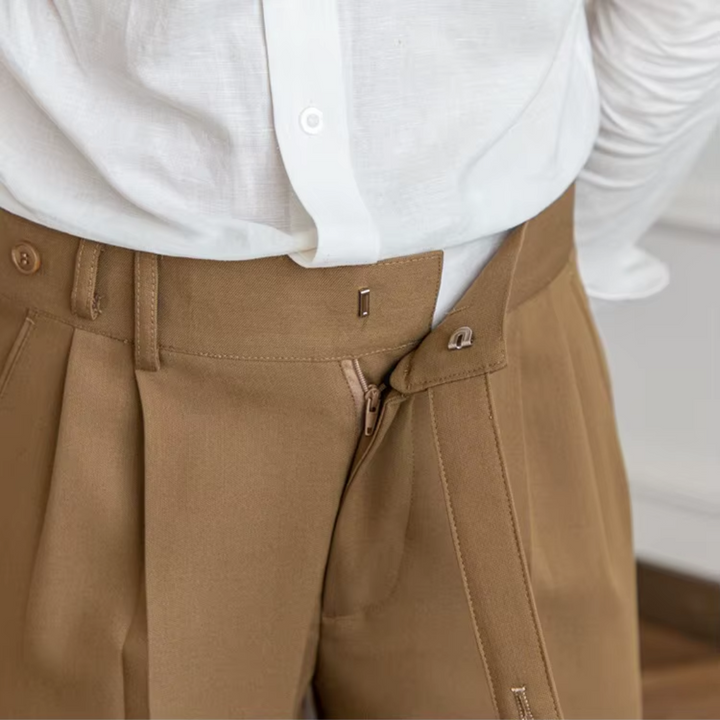 Men's elegant pleated trousers in motion, showcasing comfort & modern style for any occasion.