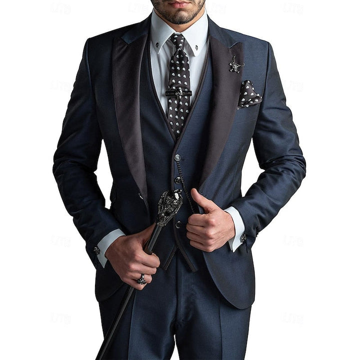 Man wearing a complete elegant three-piece suit set for a wedding or business event. Includes blazer, vest, trousers.