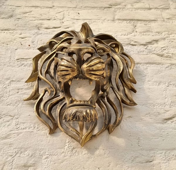 Stylish metal lion head sculpture, a bold statement piece for interior wall decor.