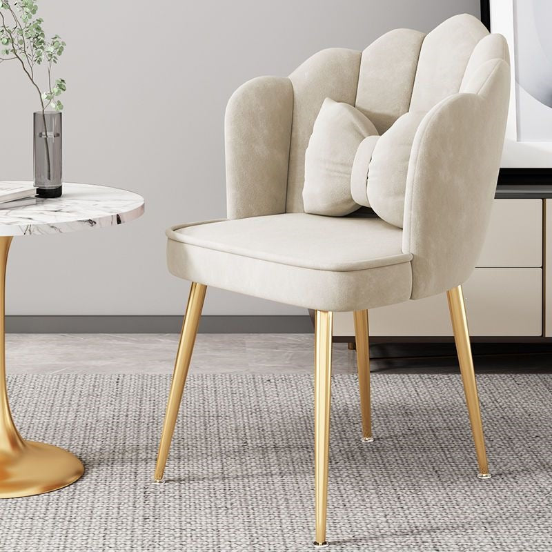 Modern bedroom chair with gold legs, providing comfortable and stylish seating.