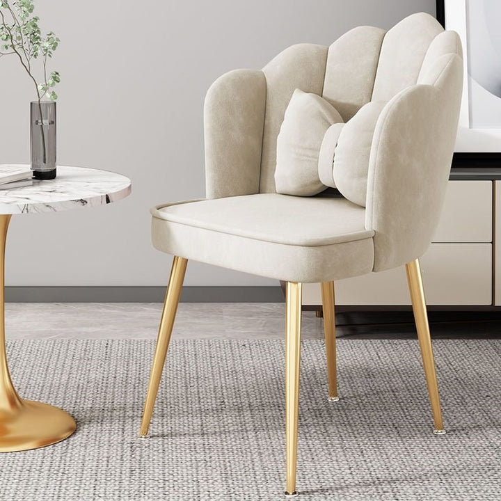 Modern bedroom chair with gold legs, providing comfortable and stylish seating.