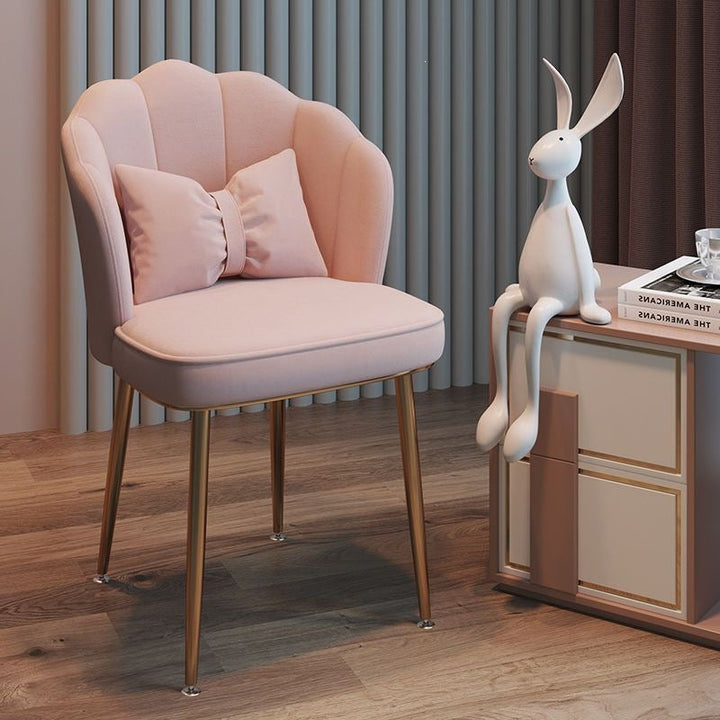 Stylish contemporary accent chair featuring slender gold legs, comfortable seating.