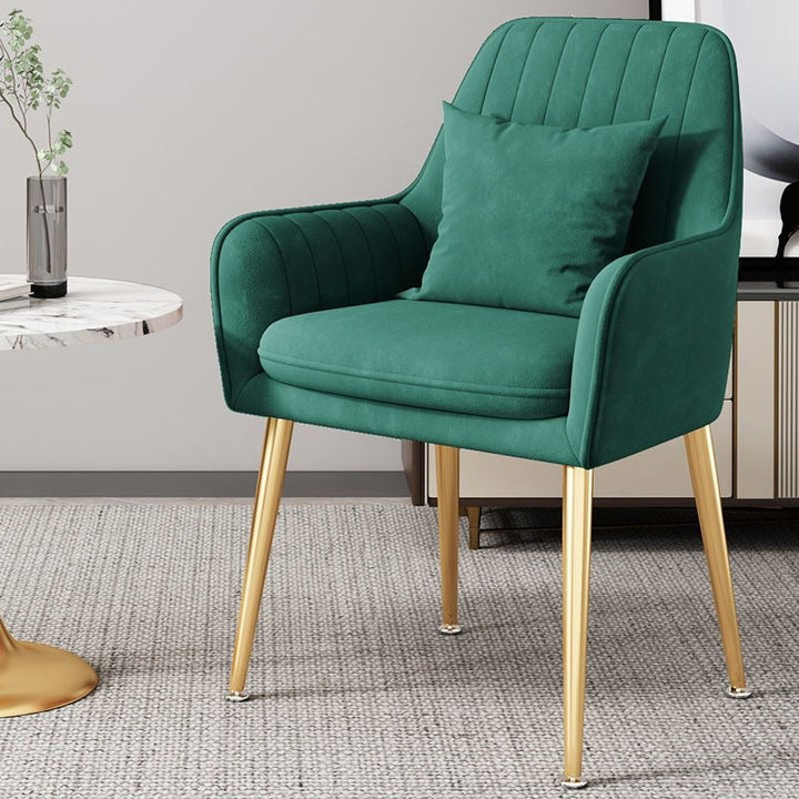 Accent chair with polished gold legs, bringing a touch of luxury to living rooms.