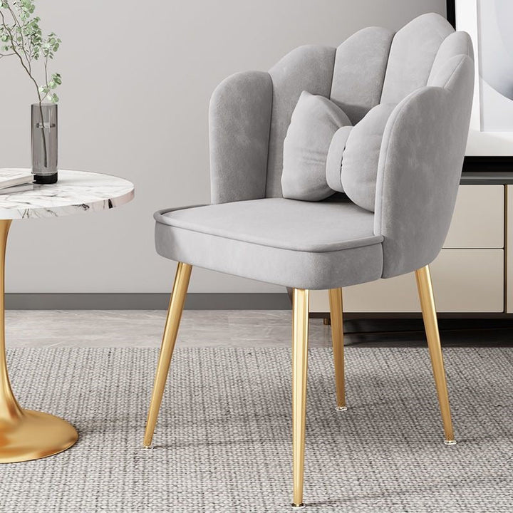 Modern chair with elegant golden legs, a stylish focal point in any room.