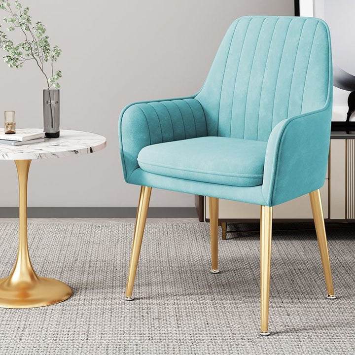 Stylish accent chair featuring slender gold legs, perfect for contemporary homes.