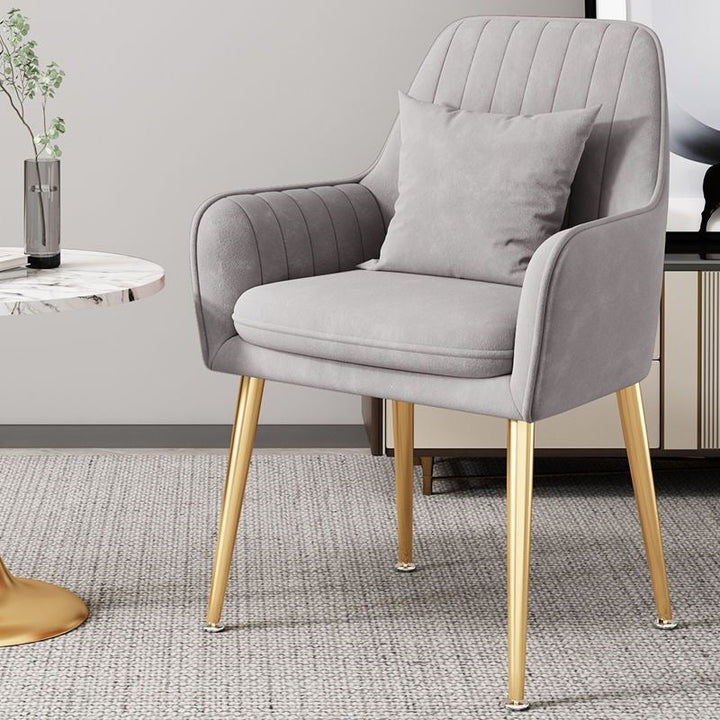 Sophisticated accent chair with golden legs, blending elegance and comfort.
