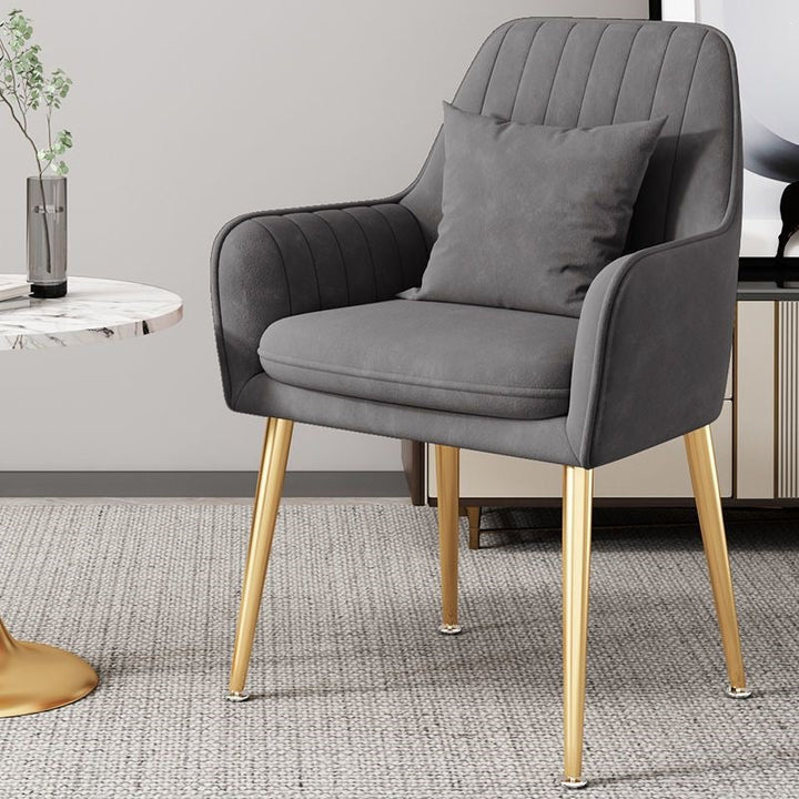 Unique gold leg accent chair, a stylish and comfortable piece of modern furniture.