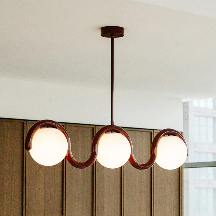 Sleek linear pendant, glass & metal, for modern dining.