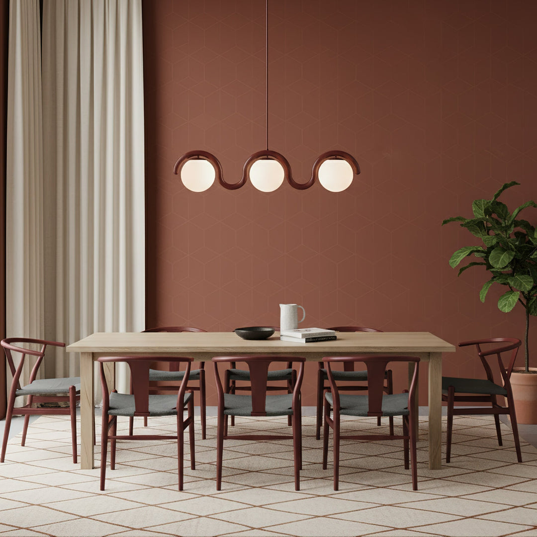 Sleek linear chandelier, glass elements, dining.