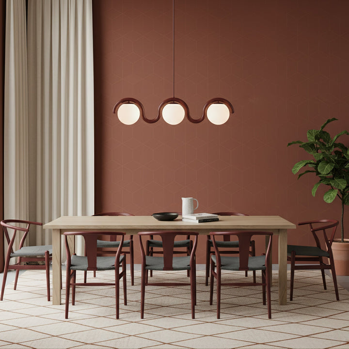 Sleek linear chandelier, glass elements, dining.