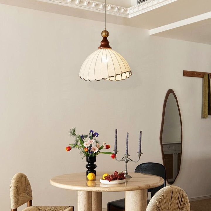 Elegant pendant light with adjustable height, featuring a beautiful fabric shade & gold accents.