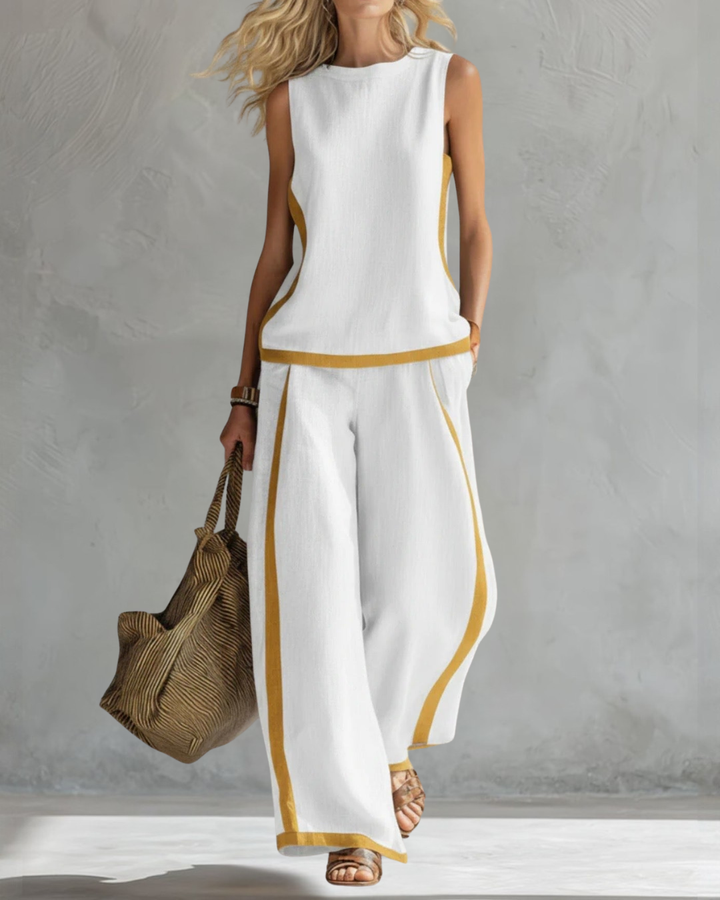 Grey women's sleeveless wide leg trouser set. Modern and comfortable attire, suitable for summer and beyond.