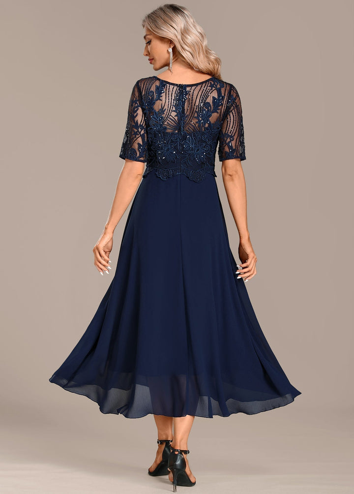 Flowy women's navy midi dress with round neck & short sleeves, comfortable & chic for occasions.