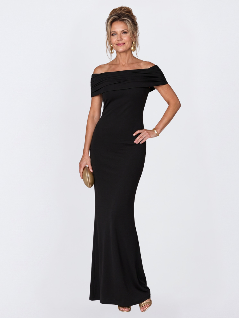 Close-up of the elegant twist-back design on a burgundy off-shoulder bodycon maxi dress, occasion wear.