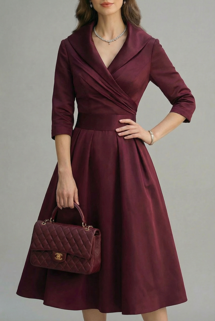 Sleek black wrap midi dress with elegant three-quarter sleeves and flared skirt.