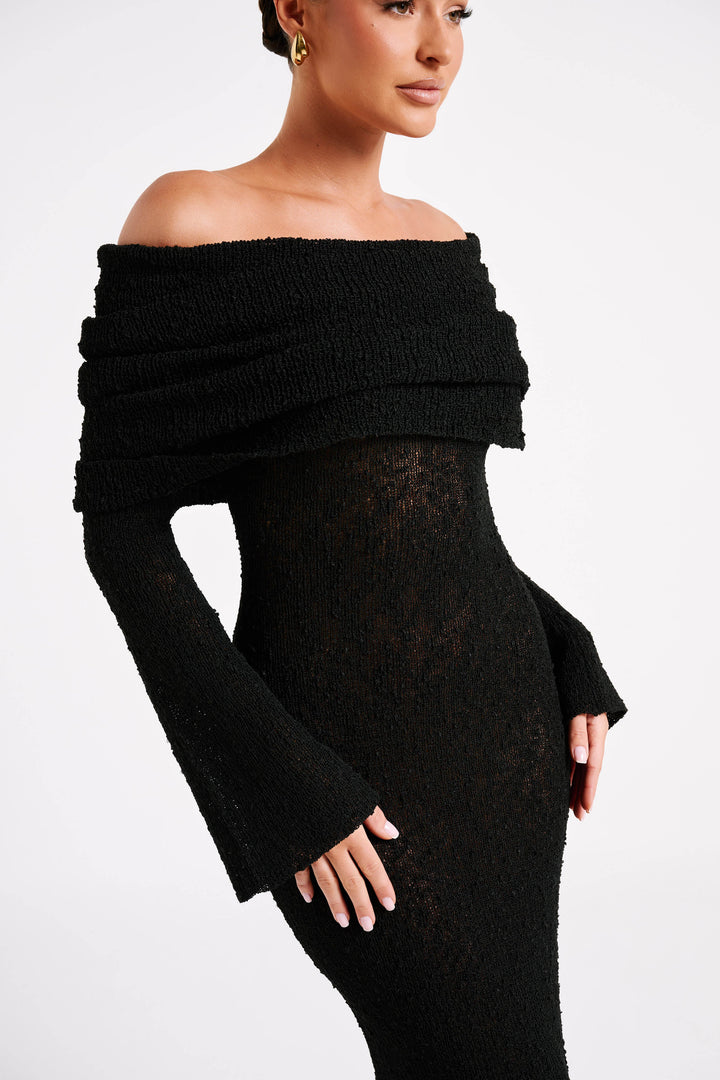 Feminine black long-sleeve off-shoulder maxi dress, perfect for elegant formal events.