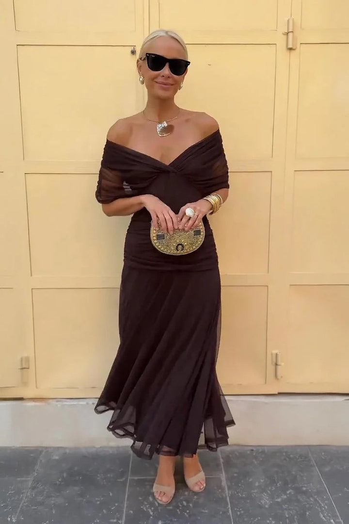 Feminine off-shoulder maxi dress, ideal vacation wear. Long, flowy, and elegant summer style.
