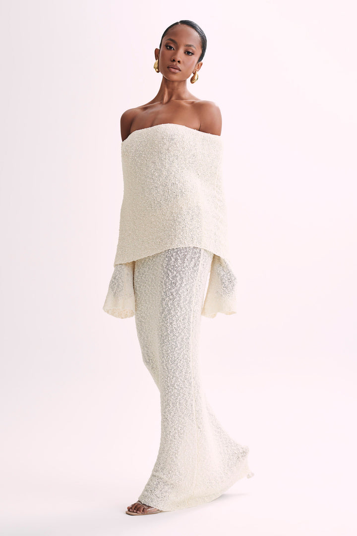 White elegant off-shoulder maxi dress, ideal for formal wear or special occasions.