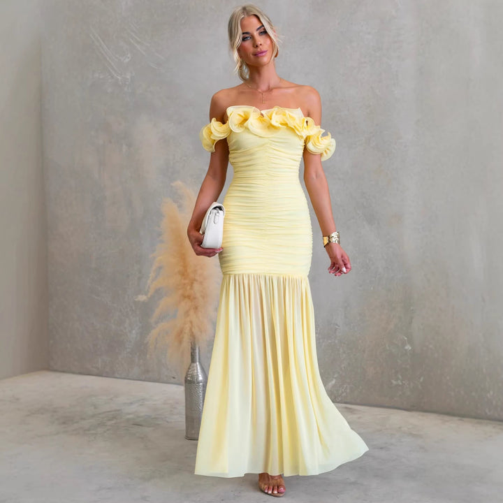 Elegant off-shoulder ruffled maxi dress for wedding guests. Perfect formal occasion wear for women.