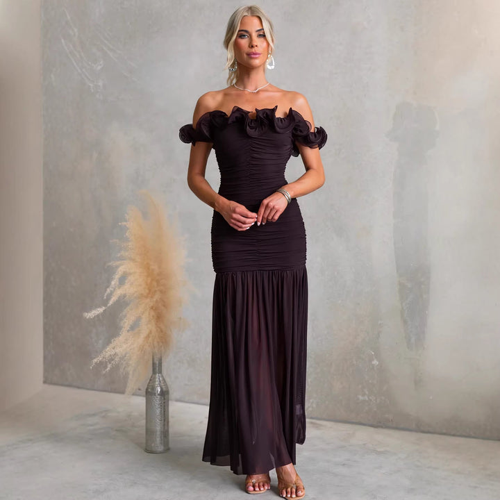 Flowing pleated off-shoulder maxi dress with ruffles, an elegant choice for women's wedding guest attire.