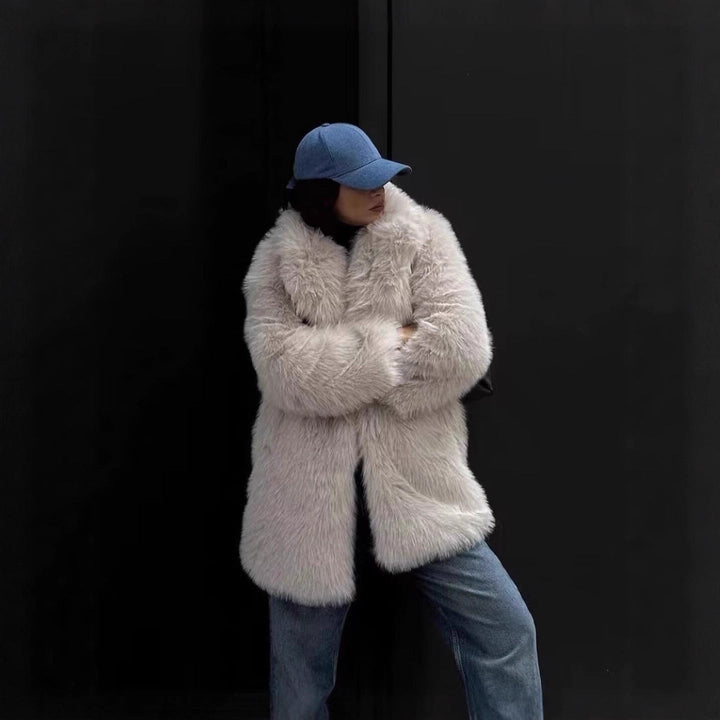 Fashionable faux fur coat in off-white, offering elegant comfort.