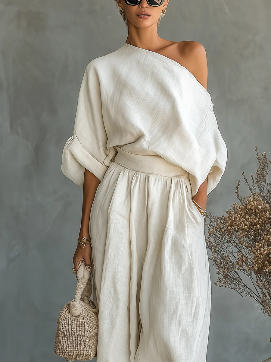 Chic women's off-shoulder top and matching wide-leg trousers in an off-white relaxed fit two-piece set.