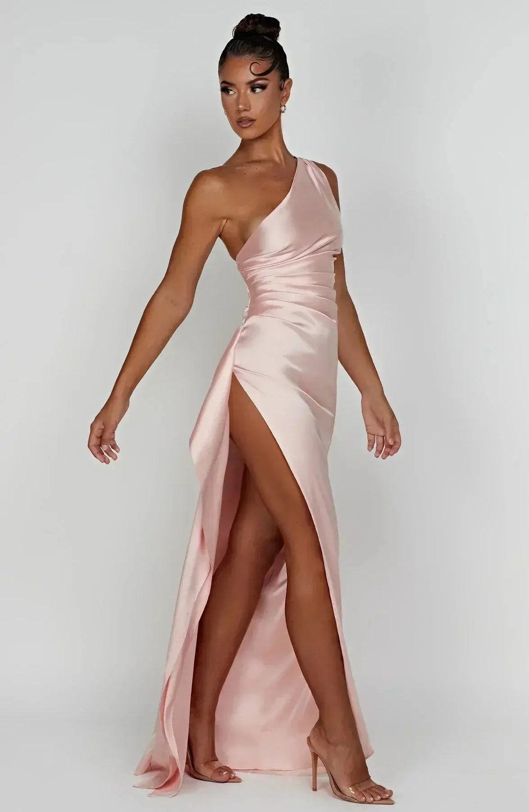 Women's formal one-shoulder gown with ruched waist, ideal for galas.