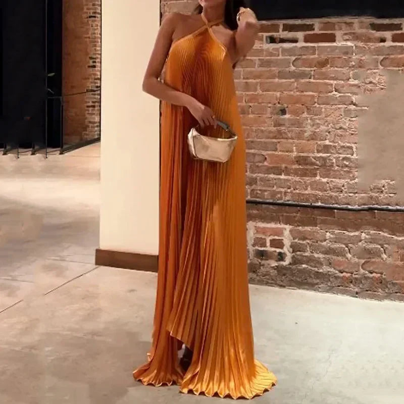 Stunning orange pleated halter neck maxi dress, an elegant choice for women attending weddings or formal events.