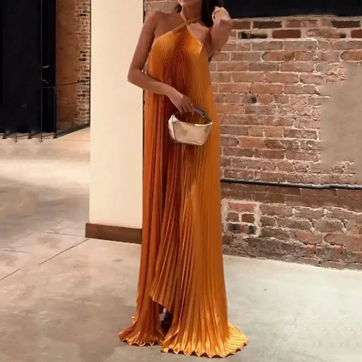 Stunning orange pleated halter neck maxi dress, an elegant choice for women attending weddings or formal events.