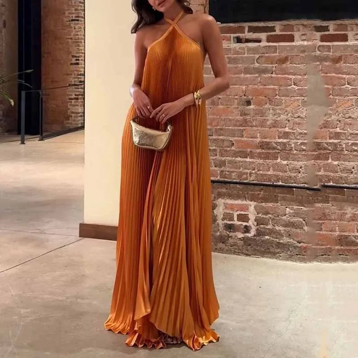 Elegant orange pleated maxi dress for women, perfect for special occasions like parties or weddings. Halter neck style.
