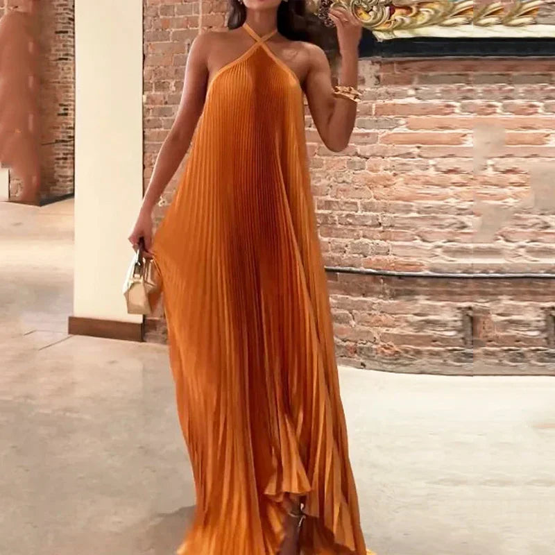 Women's formal orange pleated neckholder maxi dress. Ideal for evening events, parties, or as a wedding guest.