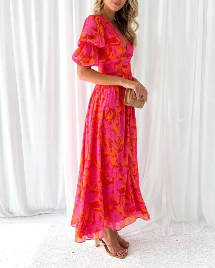 Beautiful women's elegant printed maxi dress featuring chic puff sleeves and a deep V-neck, ideal for summer fashion.
