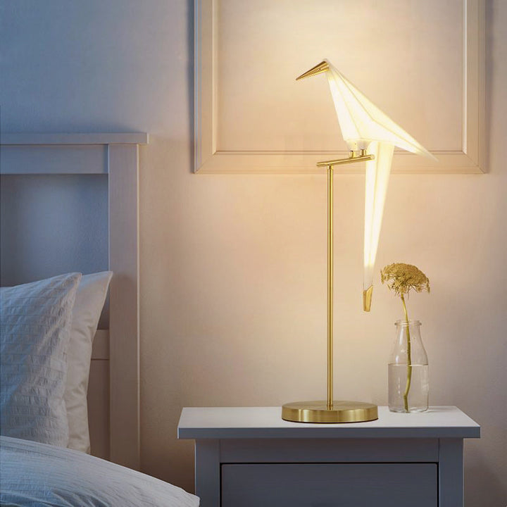 Unique origami bird lamp design, a decorative accent light providing soft, ambient home lighting.