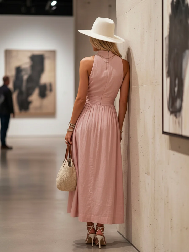 Lightweight sleeveless pink halter V-neck maxi dress, elegant comfort and flowing design for summer.