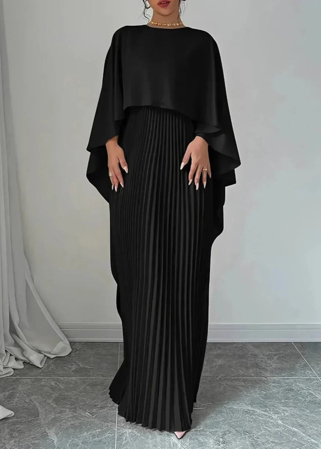 Stylish women's pleated maxi dress with a dramatic cape, perfect as an elegant wedding guest dress or evening gown.