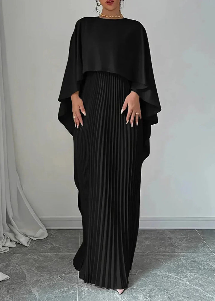 Stylish women's pleated maxi dress with a dramatic cape, perfect as an elegant wedding guest dress or evening gown.