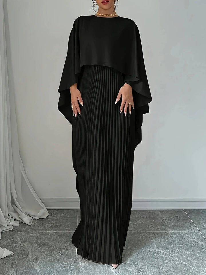 Graceful movement of a women's pleated cape maxi dress, ideal for dancing at a wedding or formal event.
