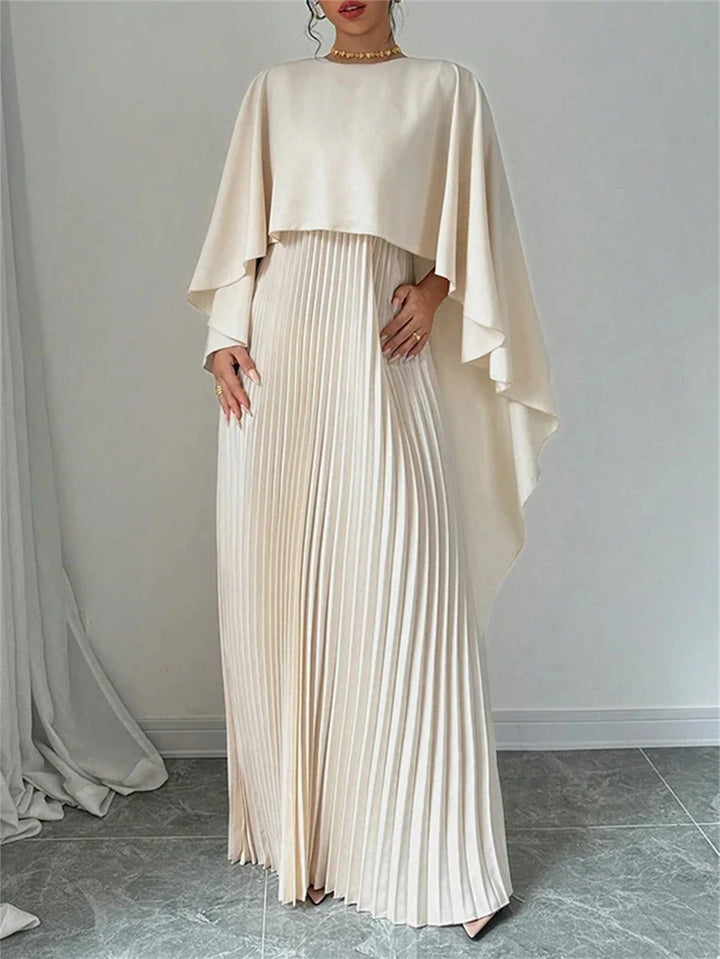 Sophisticated women's pleated maxi dress with flowing cape detail, ideal for evening wear.