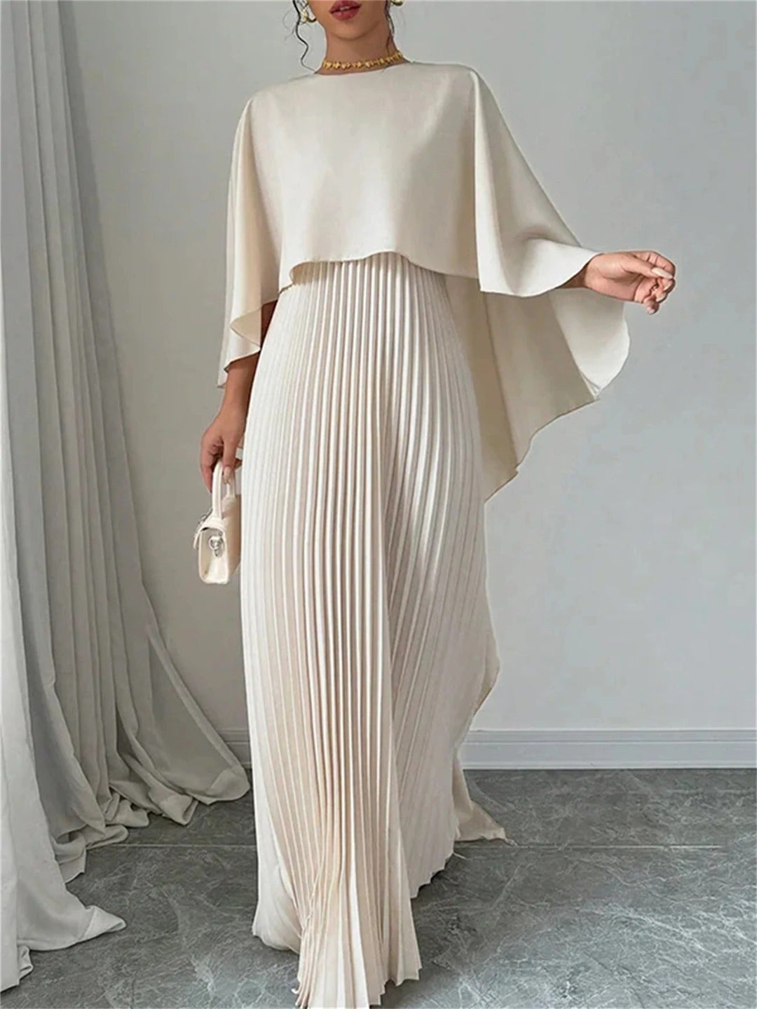 Stylish women's long pleated dress with a graceful cape, a chic choice for formal events.